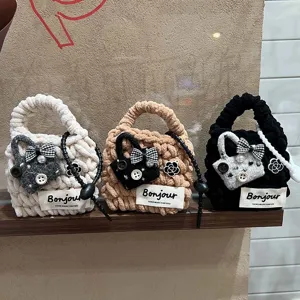 Plush handmade knitted mini earphone bag cute small storage pouch with bow detail.