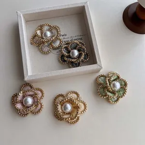 Exquisite tweed camellia brooch detail, vintage flower pin with elegant pearl center design.