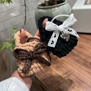 Handmade crochet mini earphone bag with cute bowknot design, plush coin purse for daily use.