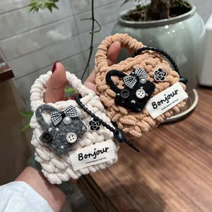Plush knit mini handbag shape earphone case detail, handmade bow and flower charm.