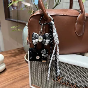 Cute black and white tweed bow and mini bag charm with braided rope for handbags.