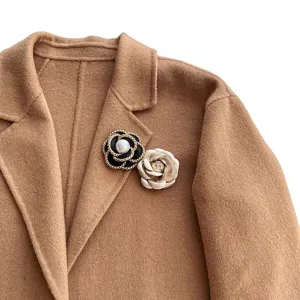 Chanel style camellia brooch with gold chain pearl and fabric flower for elegant suit and coat.
