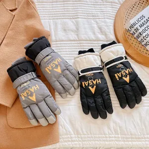 Detailed view of thermal waterproof ski gloves in grey and black, featuring windproof design.