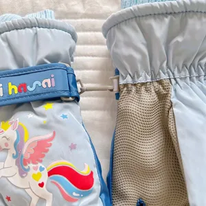 Children winter ski gloves detail view, waterproof fleece lined warm cute cartoon unicorn design.