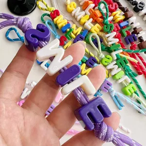 Colorful letter beaded braided rope bag charm, cute style accessory for daily use.