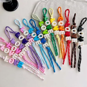 Colorful acrylic letter beaded braided strap bag charm detail showing multiple vivid colors