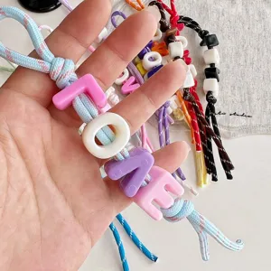 Colorful dopamine woven bag charm with chunky acrylic letter beads, trendy keychain accessory.
