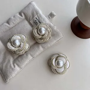 Fashionable tweed fabric camellia flower brooch with elegant pearl center for women apparel.
