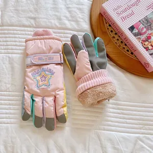 Detailed view of winter thermal ski gloves, cute star pattern, plush lining, colorful design.