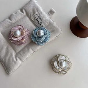 Elegant tweed camellia brooch with pearl center, stylish fabric floral pin for women.