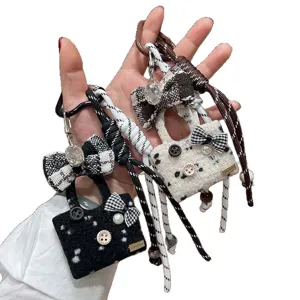 Cute tweed bag keychain charm with bow and pearls, stylish handbag pendant for keys and bags.