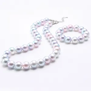 Kids pastel iridescent pearl necklace and bracelet set, cute children beaded jewelry details.