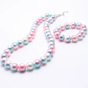 Detailed close up of pastel gradient pearl necklace and bracelet set for kids daily wear.