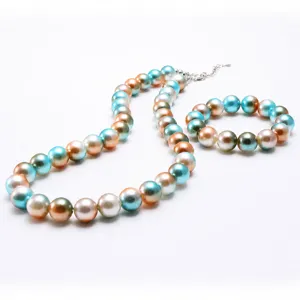 Children iridescent pearl bead necklace and bracelet set detail view showing shiny beads.