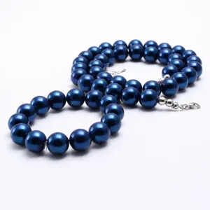Close-up detail view of blue pearl necklace and bracelet set, featuring glossy round beads.