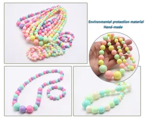Detailed view of colorful acrylic bead necklace and bracelet set for kids in pastel candy colors.