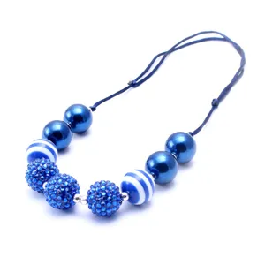 Detailed close-up of children chunky beaded necklace featuring sparkling blue resin balls.