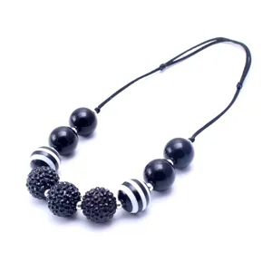 Detailed close-up view of a black and white beaded children's adjustable necklace.
