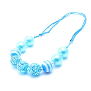 Close-up detail of blue kids rhinestone disco ball and chunky bead adjustable necklace.