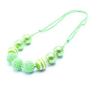 Green resin rhinestone beaded children necklace detail shot, adjustable cord kids jewelry.