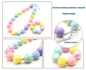 Close-up detail of colorful macaron pastel beads necklace and bracelet with sparkling finish.