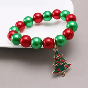 Children Christmas pearl beaded bracelet with cute tree pendant detail view for girls fashion.