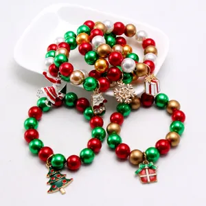 Christmas children beaded bracelet set with cute Santa and tree pendants for kids holidays.