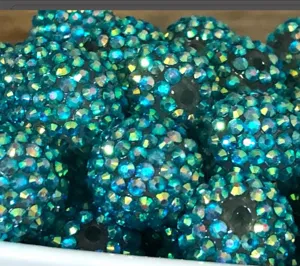 Close-up view of vibrant blue AB rhinestone chunky beads, sparkling resin craft DIY details.