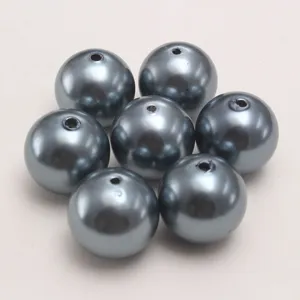 Dark gray ABS plastic imitation pearl beads detail showing drilled holes for DIY jewelry making