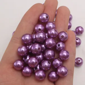 Close-up view of purple ABS pearl beads, smooth surface, perfect for DIY jewelry making.