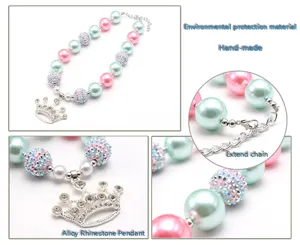 Close-up details of children pearl necklace with rhinestone crown pendant and extend chain.
