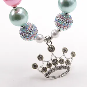Chunky kids necklace with pastel pearls, rhinestone disco balls and a sparkling crown pendant.