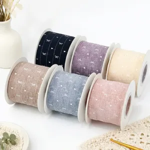 Decorative bow print ribbon rolls for gift wrapping, baking packaging, and DIY crafts.
