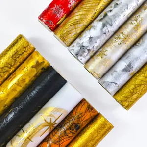 Close-up detail of metallic foil printed mesh wrapping paper rolls, multi-color festive patterns.