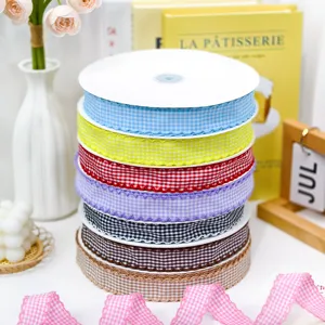 Close-up of vibrant checkered ribbons in stacked rolls with scalloped edge for DIY.