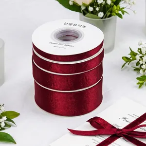 Burgundy velvet ribbon rolls for DIY hair bows, gift wrapping, and sewing crafts.