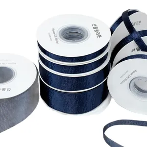 Dark navy blue double-sided shiny velvet ribbon spools for DIY hair bows and garment sewing crafts.