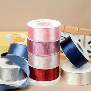 Details of shiny double-sided satin ribbon rolls, metallic crinkle texture for DIY hair crafts.