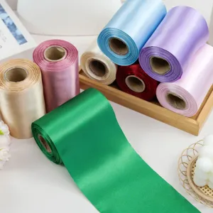 Close-up of vibrant satin ribbon rolls in various colors, ideal for gift wrapping and decor.