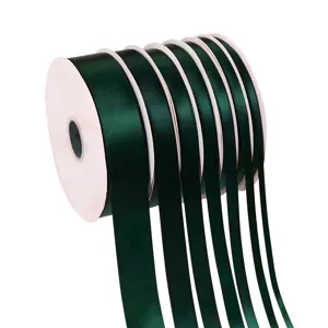 Dark green satin ribbon spool for gift wrapping, holiday decoration and bow making