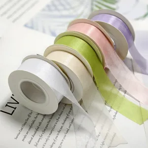 Sheer organza ribbon rolls in assorted pastel colors for gift wrapping and DIY crafts.