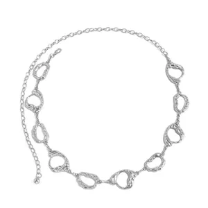Close-up detail of silver metal waist chain featuring irregular geometric links.