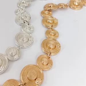 Close-up view of vintage metal waist chain featuring unique miniature hat links in gold or silver.