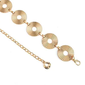Vintage gold metal waist chain detail view featuring radiant geometric disc links and extension.