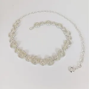 Silver metal waist chain with circular disc details, stylish vintage accessory view.