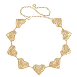Gold metallic heart waist chain belt for women, vintage retro dress fashion accessory.