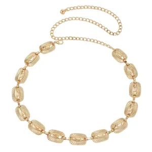Gold metal waist chain detail, intricate engraved rectangular links and delicate adjustable chain.