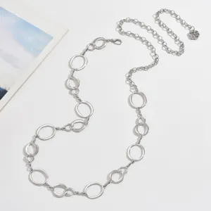Silver metal chain belt detailed with interlocking oval rings and a delicate charm accessory.