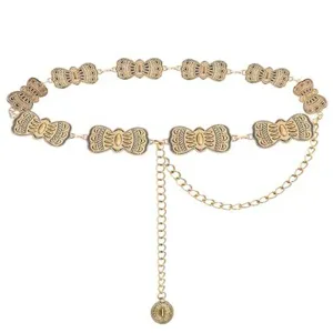 Detailed shot of retro gold metal waist chain with vintage filigree links and chains.