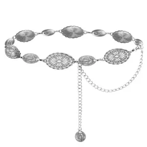 Close-up detail of vintage silver metal waist chain, boho engraved coin links and drop pendant.